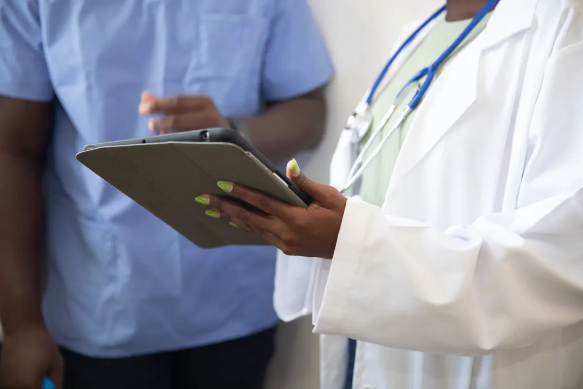 Healthcare professionals reviewing information on a tablet