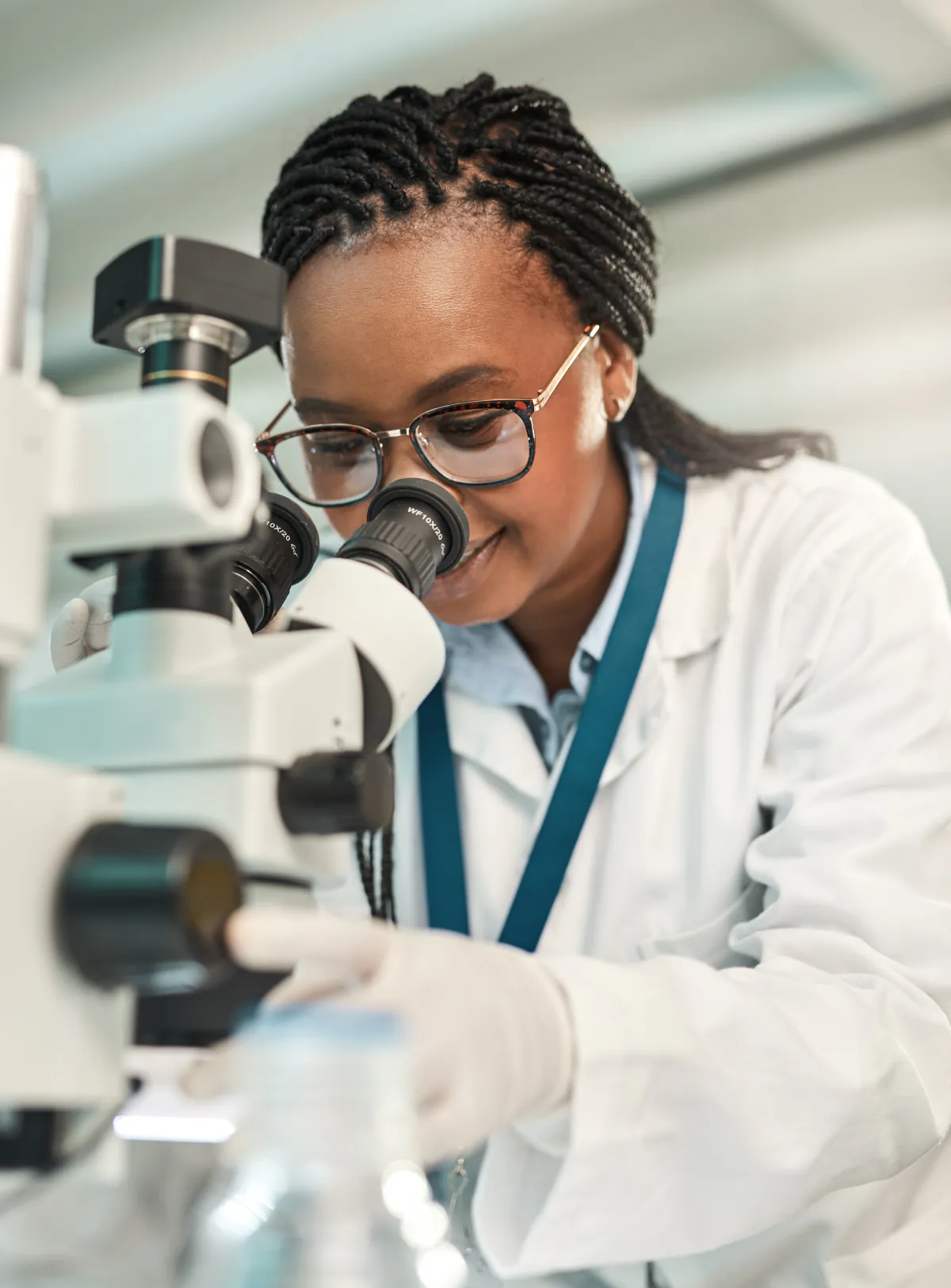 Medical laboratory professional examining a specimen with a microscope